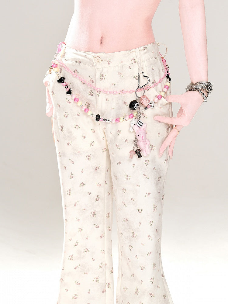 Aprikosenfarbene, schmal geschnittene Schlaghose mit niedriger Taille und Blumenmuster