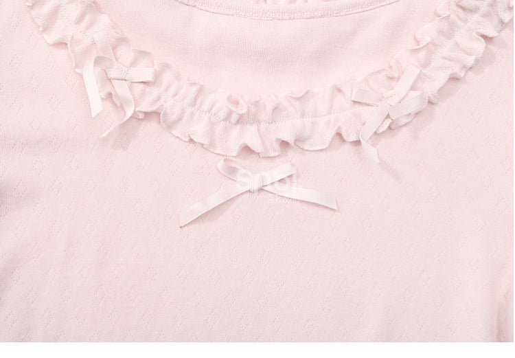 Rosafarbenes, langärmliges Oberteil mit Rüschenbesatz und Schleifendetails
