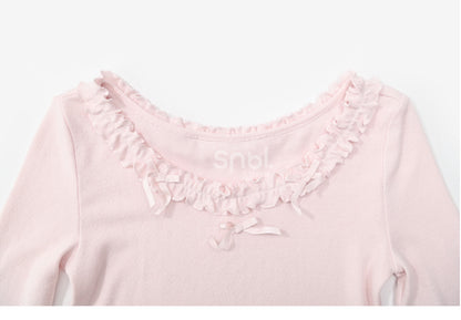 Rosafarbenes, langärmliges Oberteil mit Rüschenbesatz und Schleifendetails