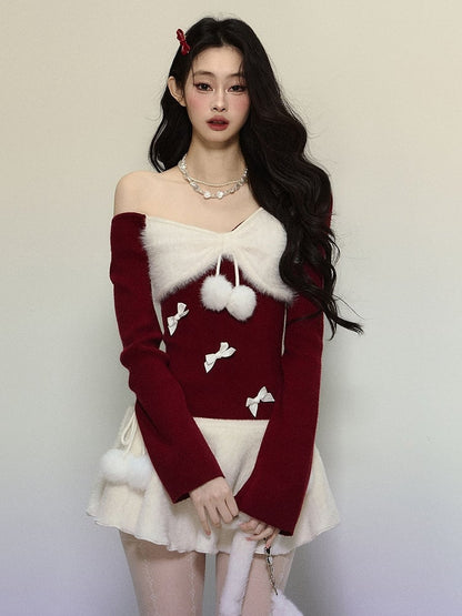 Strickoberteil mit asymmetrischem Ausschnitt und roter Schleife