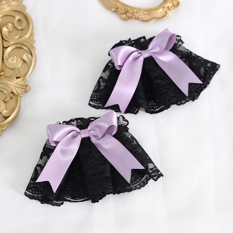 A Pair of Black Lace Wrist Cuffs With Purple Bowknot Decorations