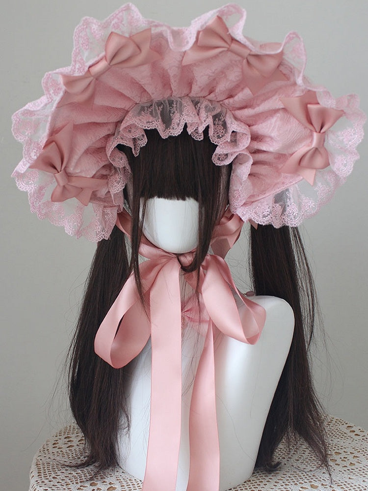 ピンクの蝶結びディテール、レーストリムのボンネット