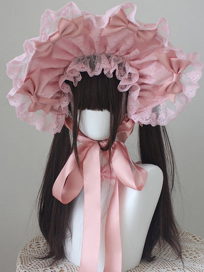 ピンクの蝶結びディテール、レーストリムのボンネット