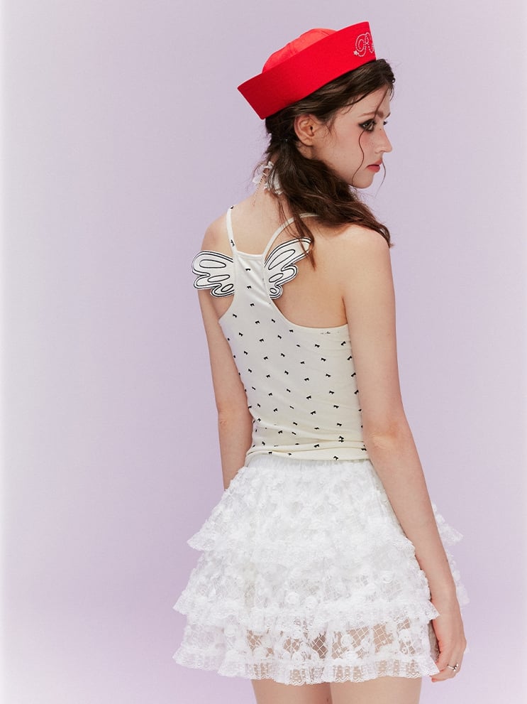 ベージュ オールオーバーデザイン バックキャミトップ 蝶結びプリント ウィング