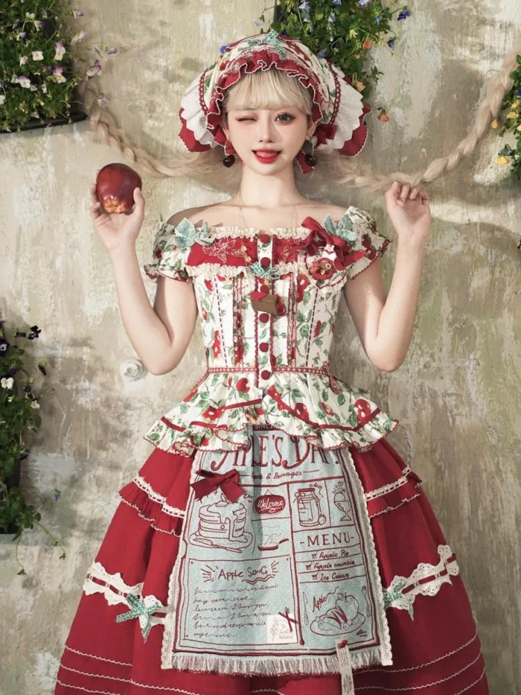 Grüne und rote Schürze mit Stickereidetail