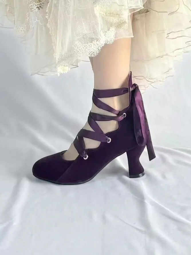 Purple pointed toe velvet heels worn side view