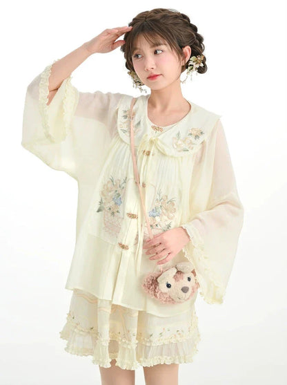 Rüschenhemd, angesetzter Rock mit chinesischem Kragen + transparenter Waldstoff