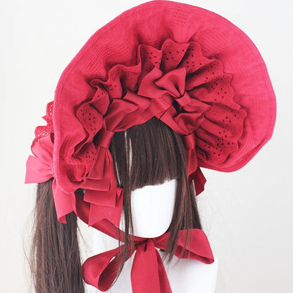 コットンの蝶結びディテール、レーストリムのボンネット