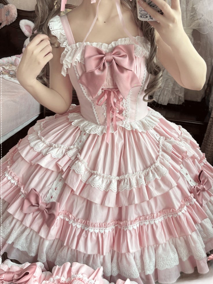 Pink tiered Sweet Lolita JSK dress with front bow and white lace trim