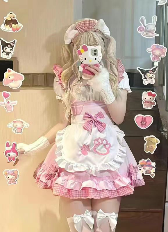 Person wearing a pink and white outfit with cartoon character stickers on a pink background