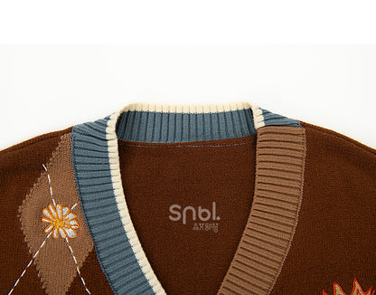 Braune Strickjacke mit Stickerei und Gänseblümchen