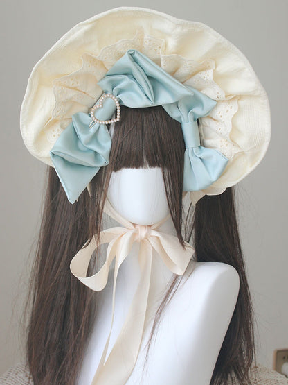 ピンク/ブルーのビーズ付き蝶結びディテール、レーストリムのボンネット
