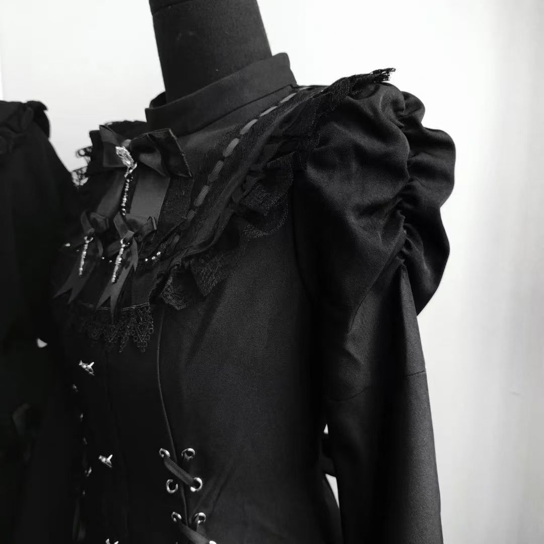Close-up of black lace neckline and shoulder ruffles on gothic Lolita dress