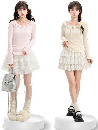 Aprikosenfarbenes, langärmliges Oberteil mit Spitzenbesatz und Schleifendetails