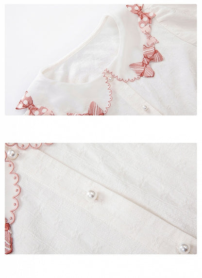 ピンクの蝶結びトリムカラーの白い半袖ブラウス