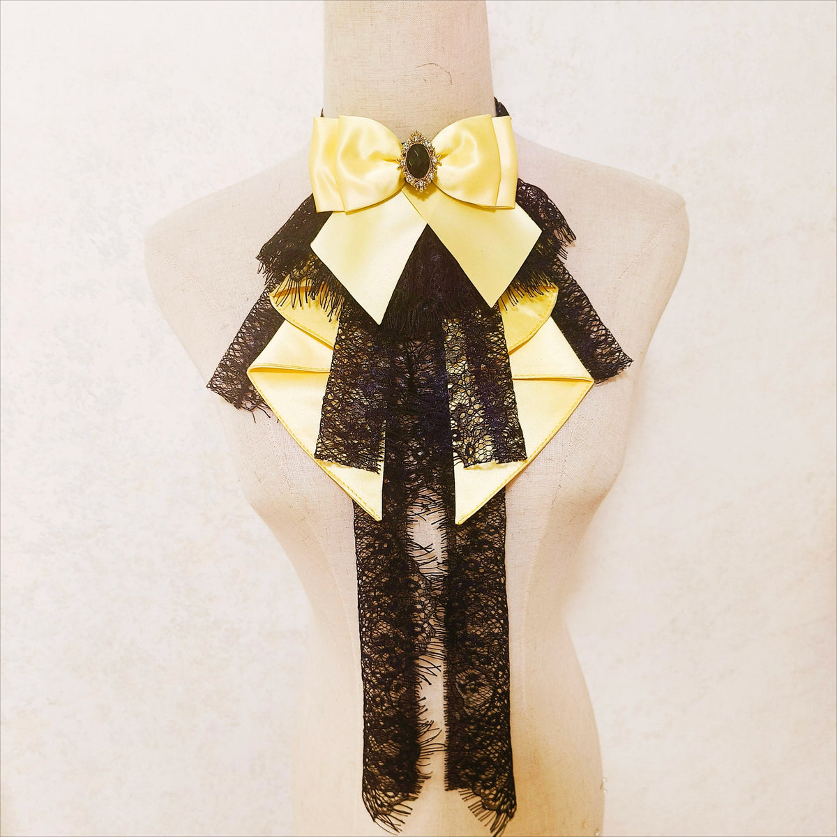Yellow bow neck accessory with dark lace layers