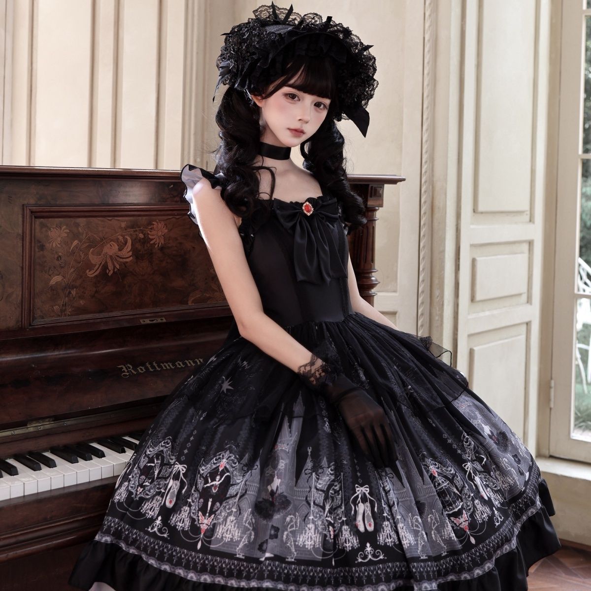 Model wearing black Midnight Ballet Gothic Lolita jumper skirt beside piano