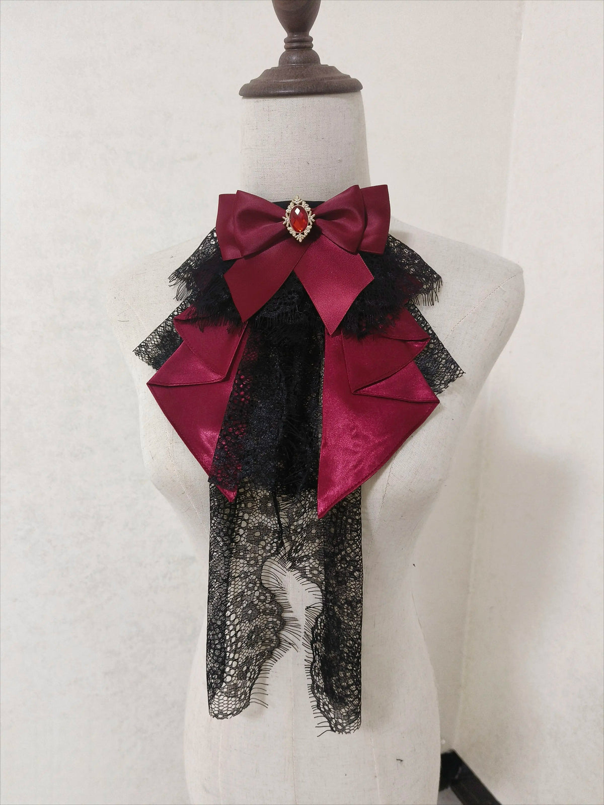 Burgundy bow neck accessory with black lace layers