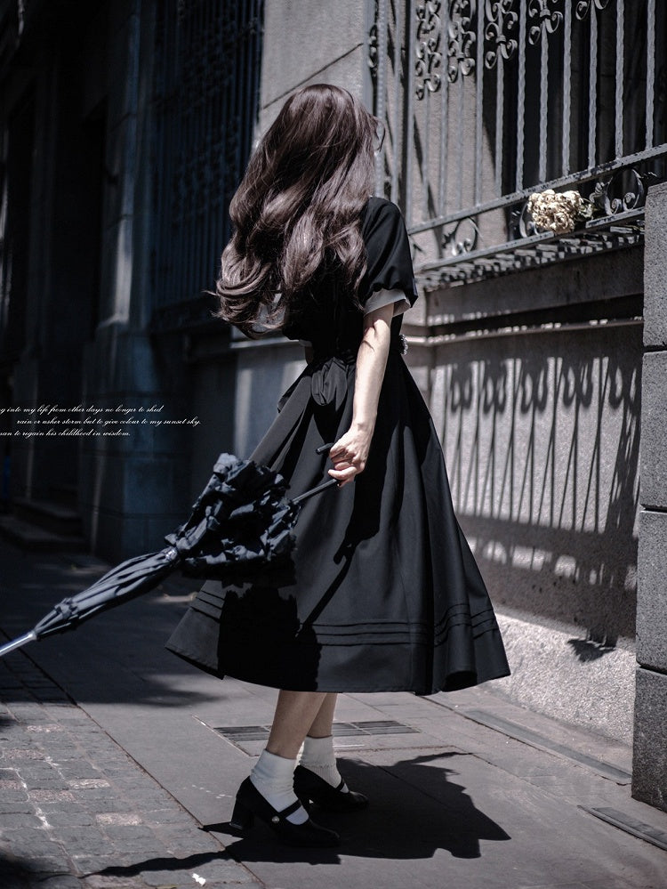 Schwarzes Puffkleid mit elegantem Ausschnitt und Ärmeln