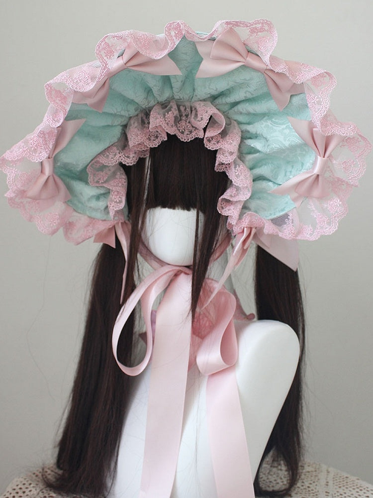 ピンクの蝶結びディテール、レーストリムのボンネット