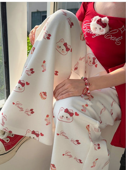 ホワイトのドローストリングウエスト、全体にキティプリントのワイドレッグカジュアルパンツ