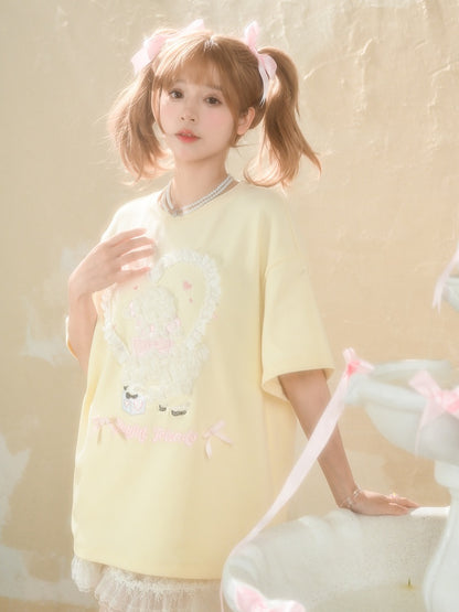 イエローのプラッシュラムアップリケフリルハートルーズTシャツクリーミー