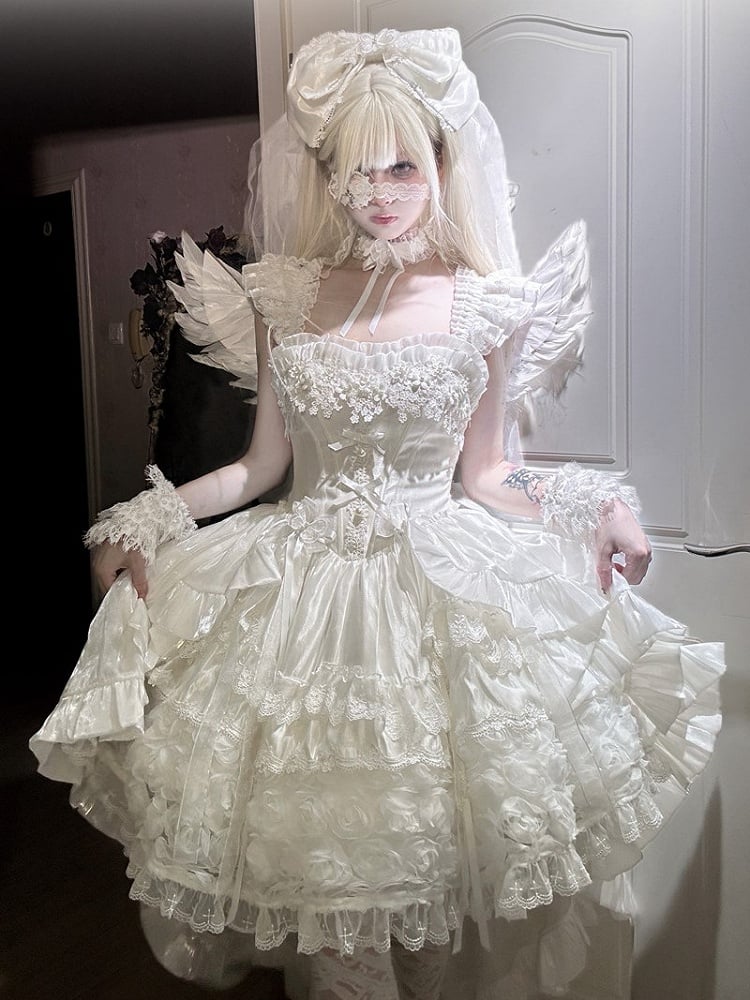 Person wearing an elaborate white dress with ruffles and a large bow headpiece.