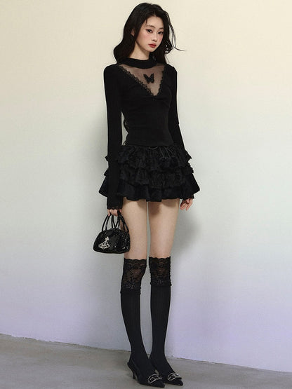 Schwarzes, langärmliges Top mit Illusionsausschnitt und Schmetterlingsakzenten