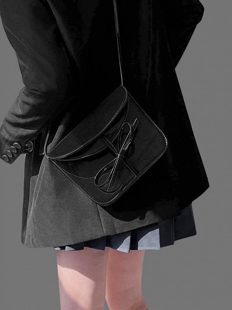 Elegant Black Crossbody Phone Pouch With Glossy Finish And Bow Accent