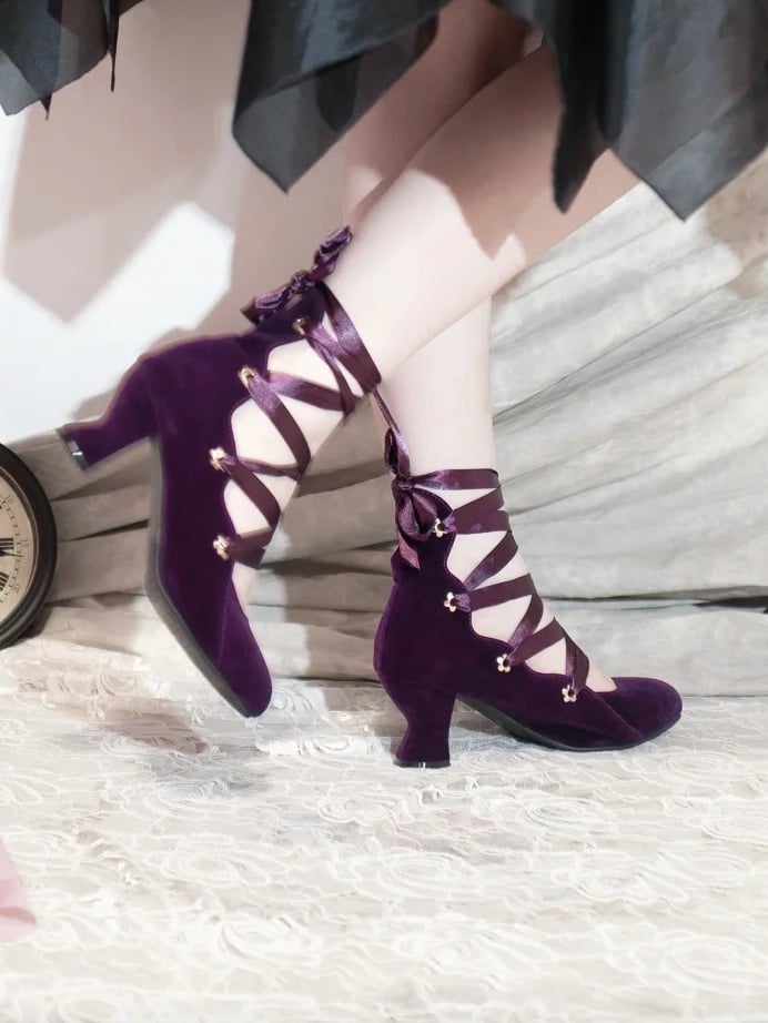 Purple velvet high heels worn in side profile