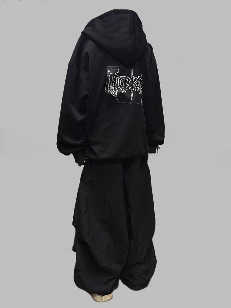 Schwarze Jacke mit Zweiwege-Knopfleiste und Reißverschluss