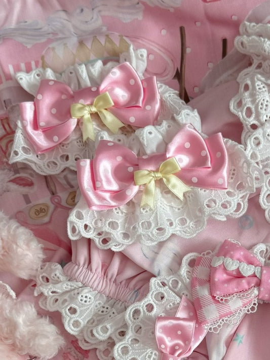 Gemusterte Handgelenkmanschetten mit rosa/gelbem Schleifendesign und Polka-Dot-Muster