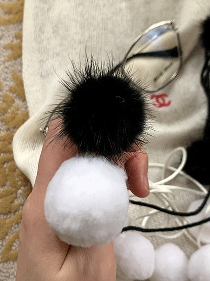 黒/白の水玉模様のポンポン付きタイツ