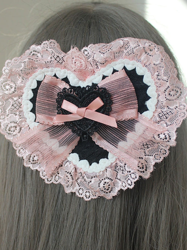 Rosa Haarspange in Herzform mit Schleife und Spitzenbesatz