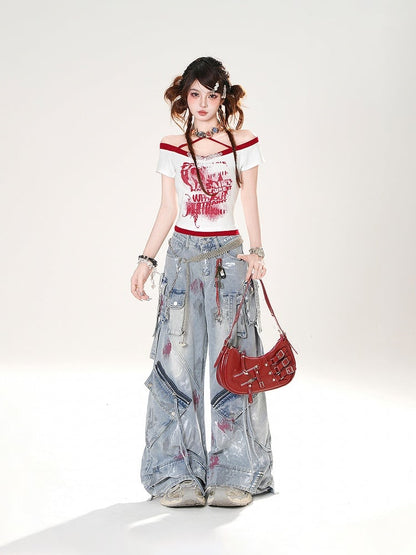 控えめなディテールのダメージ加工スプレーペイントプリントのブルーワイドレッグジーンズ。ライズジッパー付き。