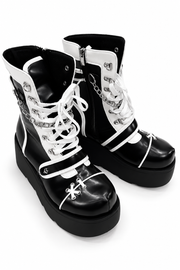 Front angled view of black-and-white platform boots