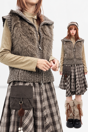Brown fuzzy sleeveless cardigan layered over a shirt