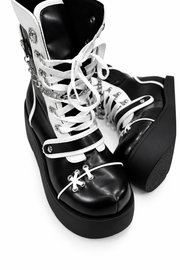 White lacing and curved trim on platform boots