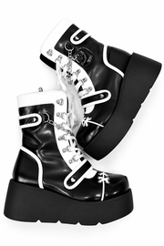 Black platform boots with white trim and decorative chains