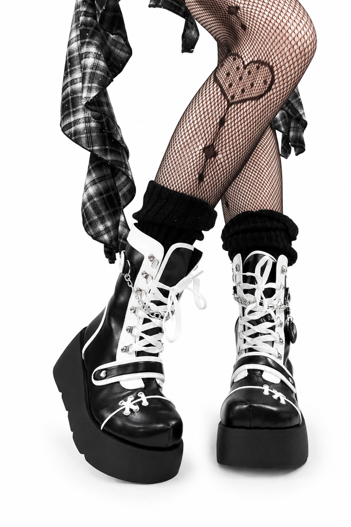 Black-and-white platform boots worn with patterned tights
