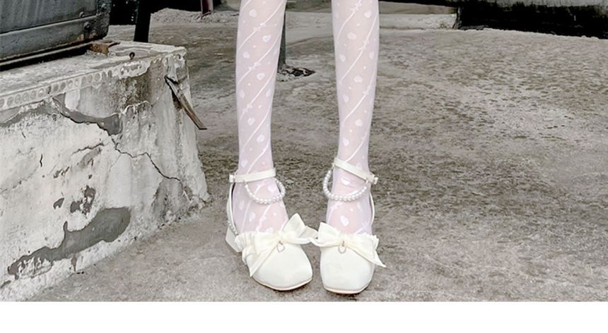 Strumpfhose mit Schleifenmuster und Herzen