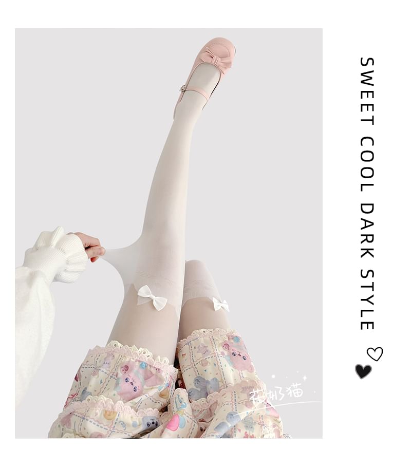 Transparente Strumpfhose mit Katzenmuster und Schleife