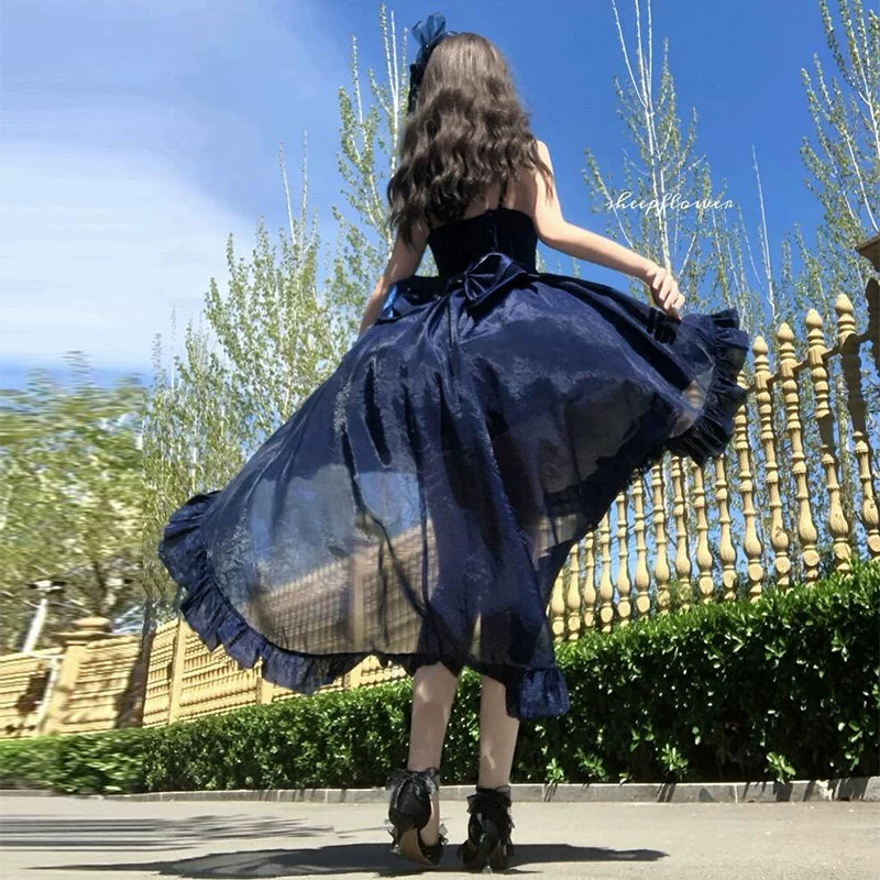 Blue dress with long trailing skirt, rear view outdoors