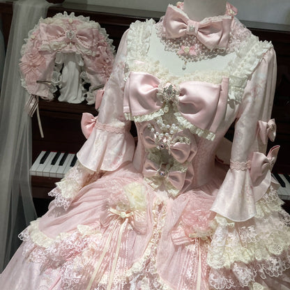 Pink Rococo Lolita dress bodice close-up with lace trim and bows