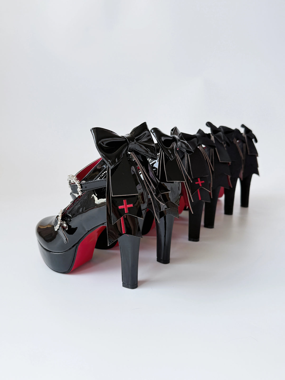 Holy Relic Cross black platform heels showing rear bows and cross details