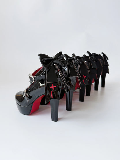 Holy Relic Cross black platform heels showing rear bows and cross details