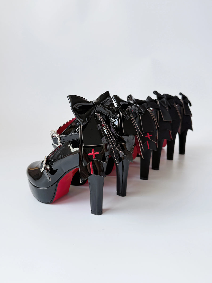Holy Relic Cross black platform heels showing rear bows and cross details