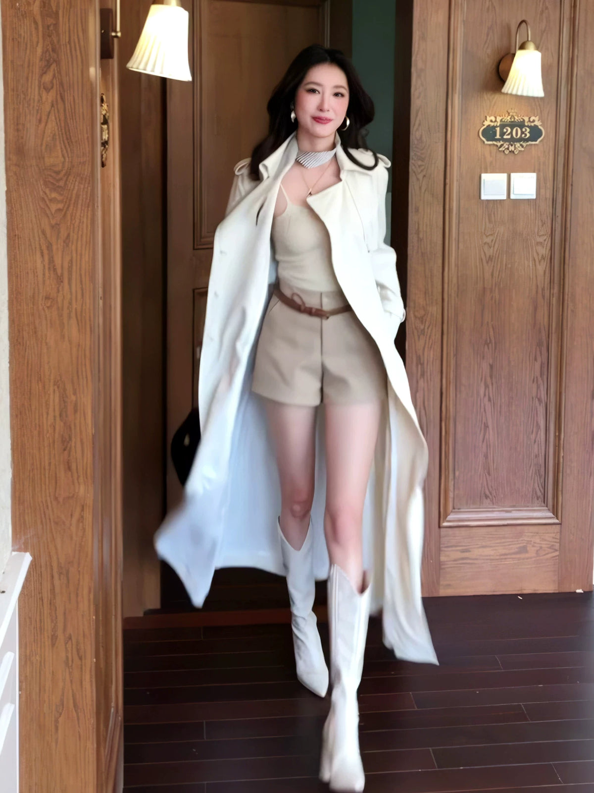 White longline trench coat worn open over a neutral outfit