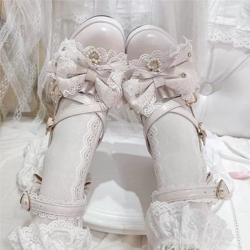 White bow Mary Jane shoes shown on feet with lace socks