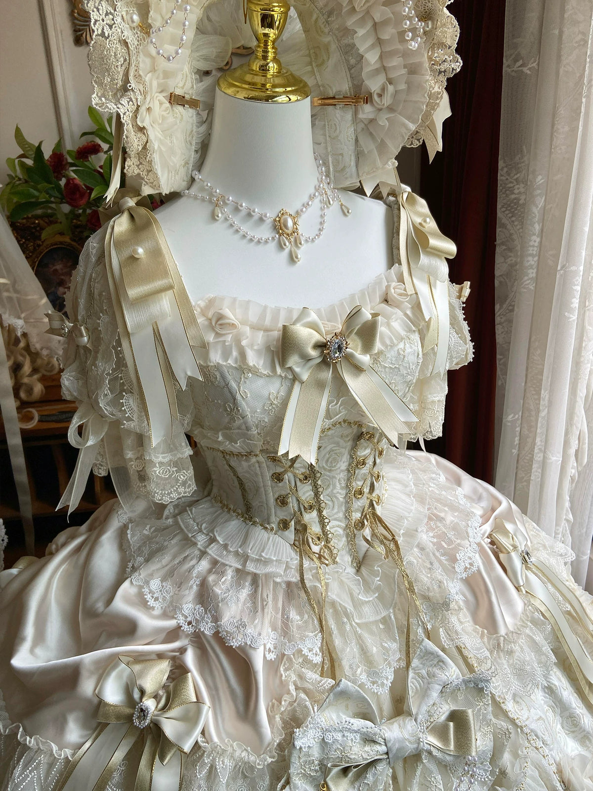 Bow and neckline details of the ivory and gold princess dress